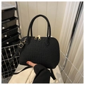 Detail of black shell bag featuring crocodile-embossed texture and gold-tone zippers - Black