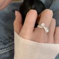 S925 silver ring featuring a pink zircon and wrinkled bow design on a female hand - J5059 Silver Pleated Bow Ring