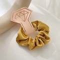 Golden satin scrunchie accessory displayed on a stylish pink diamond-shaped card - With Diamond Card / Turmeric