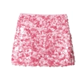 Detailed view of pink sequins on a knit mini skirt showing texture and metallic luster - Pink