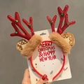 Close-up of red glitter reindeer antlers with green bells and festive faux fur detail - Red Antlers (No Paper Card)