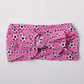 Detailed view of pink nylon baby headband with football prints and large bow - Pink Soccer Pattern