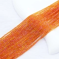 Detailed macro view of 2mm orange faceted crystal beads arranged in multiple strands - 2mm (Approx. 210 Beads per Strand) / Gold Rose Red