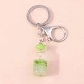 Llavero de botella de deseos de limón verde con clip plateado sobre fondo rosa - Verde Kiwi (YZ126mihoutao)