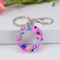 Letter O keychain with colorful shell fragments in clear resin and silver lobster clasp - Letter O