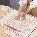 Red silicone baking mat with measurement markings and scale shown during dough kneading - Silicone / 60*40cm Transparent Red