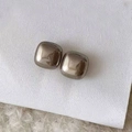 Close-up of minimalist polished square metal stud earrings on a textured white background - 14mm / 14mm Grey