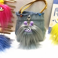 Close-up of grey long-haired monster charm with purple ears on a blue denim bag - Single Piece / Gray