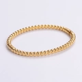 Bracciale rigido dorato minimalista con sfere lucide e chiusura a scatto rapida - Oro