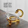 Handmade glass tea strainer with amber dragon handle and dragon head feet design - Yellow Dragon Tea Strainer