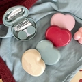 Detailed top view of heart-shaped contact lens cases with mirror and care tools - Multicolor