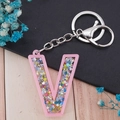 Pink acrylic letter V keychain with colorful glitter sequins and silver metal clasp - Letter V