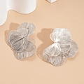 Detailed view of silver hollow flower stud earrings with multilayered metallic petals - Small / Silver