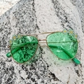 Close-up of kids aviator sunglasses with green lenses and daisy flower enamel detail - Green