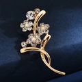 Detail of floral brooch in gold finish with sparkling crystals on dark blue fabric - Classic Flower Cluster