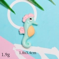 Detailed view of seahorse resin accessory with dimensions 1.8x3.4cm and weight 1.9g - Blue Pink Seahorse