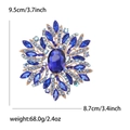 Vintage-Brosche aus Gold mit großem blauem Kristall und funkelnden Strasssteinen - Blau