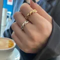 Stackable gold and silver twisted rope rings shown in a cozy cafe setting for women - Twist Braided Style (TJZ169)