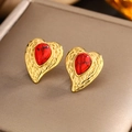 Macro view of gold heart stud earrings with textured twist edge and red stone inlay - Gold Red Turquoise E-245
