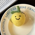 Handmade yellow wool felt lemon keychain with smiling face and green leaf detail - Lemon Single