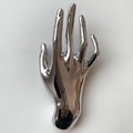 Polished silver hand sculpture brooch in a metallic open palm design for suits - Silver