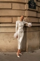 Detailed close-up of white sequined evening gown sleeves with plush feather cuffs - XS / White