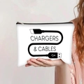 Detail of hand holding a canvas bag for chargers and cables with black zipper closure - Charger Cable Storage Style