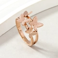 Rose gold stainless steel butterfly ring with frosted and polished textures on white stand - US 6 / Rose Gold