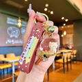 Luminous snowflake liquid sand keychain with bear milk tea charm and red strap - Milk Tea Bear Lollipop