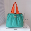 Foldable tote bag in green and orange colorway with 54x42cm dimensions shown - XL Lake Blue
