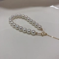 Macro detail of high-luster Aurora pearls and adjustable 14k gold-plated spring clasp - 14K Gold Filled-Aurora Tennyo White (6mm)