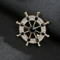 Nautical ship wheel brooch pin in gold finish with dark blue and white rhinestones - Rudder Gold Blue Stone