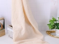 Creamy white muslin baby blanket with lace tassels and a soft crinkled texture - Beige