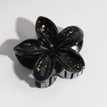 Detail of black lily hair claw clip with glossy finish and gold glitter accents - Black Gold Polka Dot