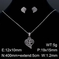 Silver stainless steel heart jewelry set with cutout spiral patterns on black background - Silver