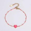 Detailed macro of gold-plated stainless steel chain with pink enamel heart and beads - Pink