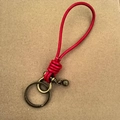 Handmade red braided leather keychain with bronze horseshoe buckle and small bell accessory - Red Leather Rope Bronze Horseshoe Buckle with Bead