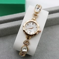 Close-up of gold quartz watch with sparkling rhinestones and heart-shaped chain bracelet - Rose Gold + White