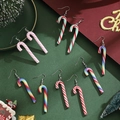Five pairs of candy cane Christmas earrings with festive stripes on a green holiday backdrop - Candy Cane Earrings Set 5 Pairs-SD251425-6