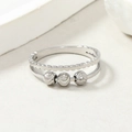 Detailed macro shot of silver stainless steel ring with three movable textured beads - Double Layer Steel Color Crescent Beads