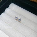 Macro detail of three-petal flower stud earrings with sparkling silver cubic zirconia stones - Silver