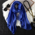 Elegant royal blue chiffon long scarf draped on plush white mat with fashion accessories - Sapphire Blue