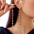 Gold long drop earrings featuring colorful heart-shaped beads worn by a model - Earrings / Gold Multi-color