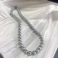 Detailed view of silver-gray Akoya-style pearls on white pleated silk fabric - S925 Silver Buckle/Faux Pearl / 12mm/43cm