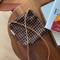 Macro shot of plaid wool crossbody bag with leather strap on a rustic wooden table - Orange Coffee Small Plaid