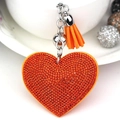 Llavero de corazón en cuero naranja con pedrería brillante y borla a juego - Tono Plateado + Naranja
