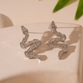 Macro detail of silver snake stud earrings with clear rhinestones on stone background - Snake Shape (WE1424) / Silver