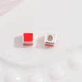 Macro shot of red enamel heart-shaped square cube charm bead with side hole - White Gold and Red Square Style