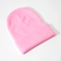 Macro shot of hot pink ribbed knit beanie showing high-quality acrylic texture and fold-up cuff - Pink