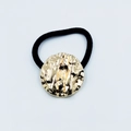 Elegant black hair tie featuring a golden hammered metal disc with ripple texture - Water Wave Round Disc (Hair Tie 89)